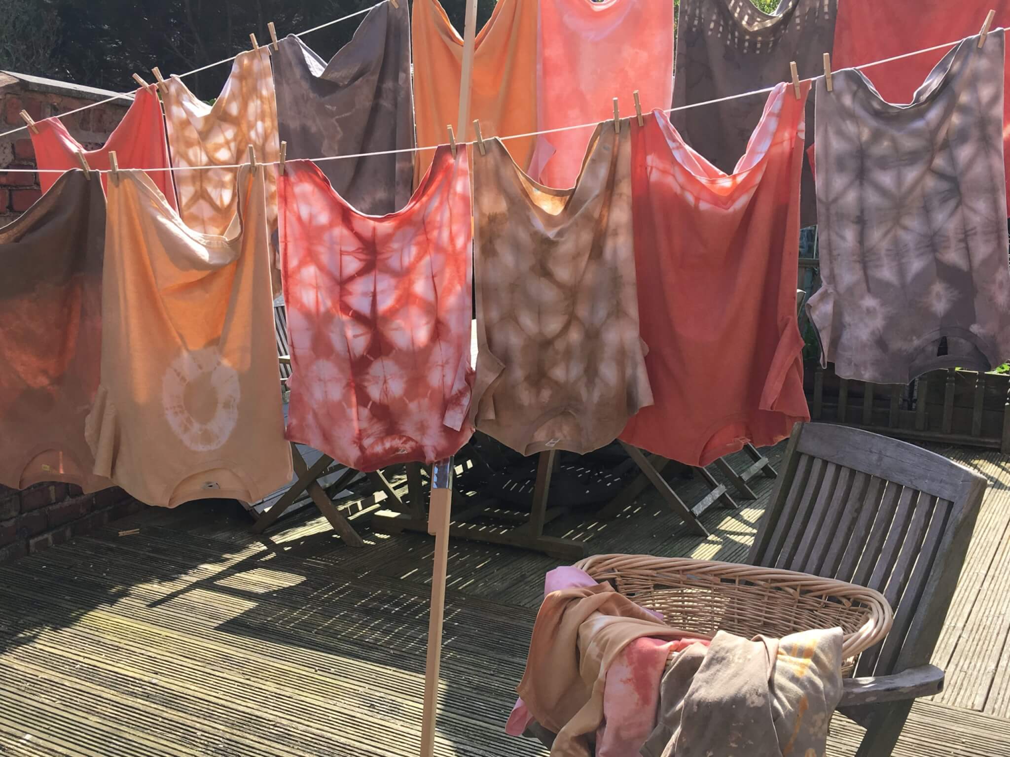 Botanically dyed T shirts on a washing line in the North West England Fibreshed region